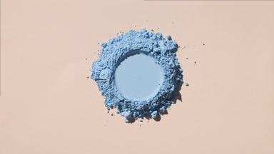 Overhead View of Soft Blue Powder with Imprint on Tan Backdrop