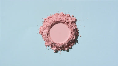 Top View of Pale Pink Powder with Imprint on Light Blue Canvas
