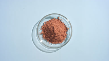 Above View of Brown Powder in Lab Dish on Soft Blue