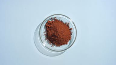 Top-Down View of Brown Powder in Shallow Glass Dish