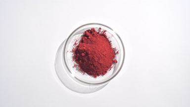 Aerial Capture of Red Powder in Glass Dish