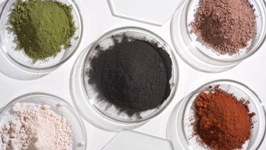 Colorful Powders in Petri Dishes on Soft Gray Background