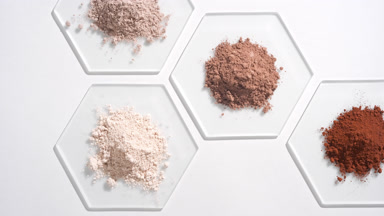 Aerial View of Colorful Cosmetic Powders on Glass