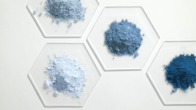 Overhead Shot of Blue Cosmetic Powders on Glass