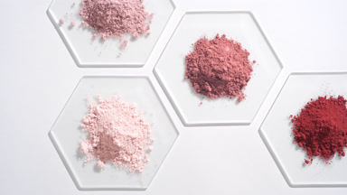Aerial View of Pink Cosmetic Powders on Hexagonal Glass
