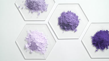 Bird's Eye View of Violet Cosmetic Powders on Glass