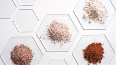 Overhead View of Beige and Brown Powders on Gray Glass