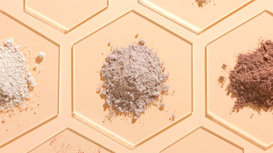 Top-Down View of Beige and Brown Powders on Canvas