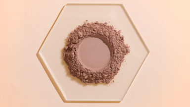 Brown Fine Powder with Round Imprint on Glass