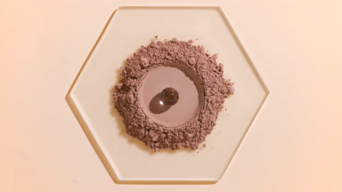 Brown Fine Powder with Hydrogel Sphere on Glass