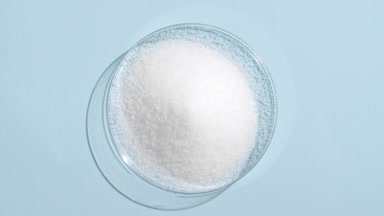 Top View of White Powder in Petri Dish on Light Blue