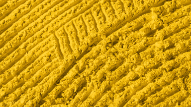 Yellow Powder Surface with Furrows and Shifting Shadows
