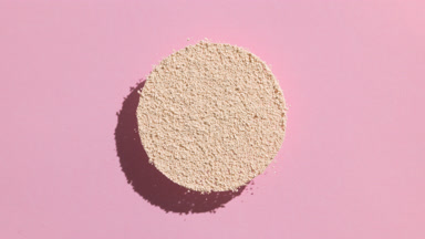 Dynamic Shadow of Beige Powder on Pale Pink Background