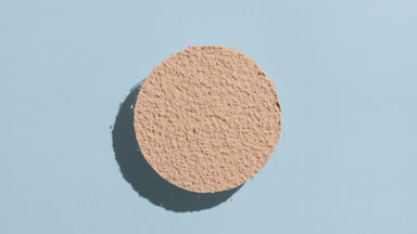 Beige Powder Shadow Play on Pastel Blue Surface