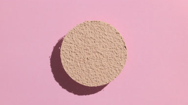 Moving Shadow of Beige Powder on Pastel Pink Background