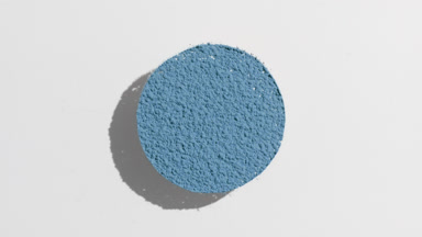 Moving Shadow of Blue Powder on Muted Grey Background