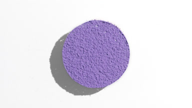 Violet Powder Sifting in Circular Shape on White Surface