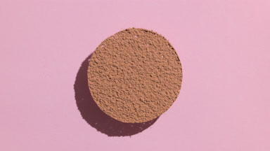 Brown Powder Sifting in Circle with Lively Shadows