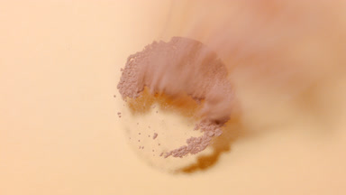 Skintone Powder Sifting in Slow Motion on Beige Background