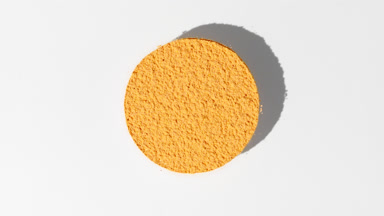 Dynamic Yellow Powder on Grey Background for Cosmetics