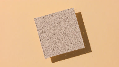 Dynamic Shadows of Beige Powder on Tan Background