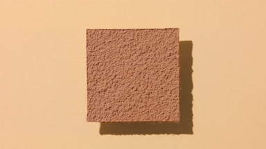 Brown Powder Sifting on Transparent Surface
