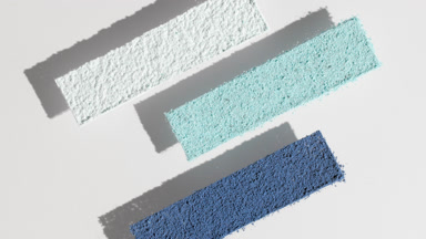 Moving Shadows of Blue, Cyan, and White Powder on Grey