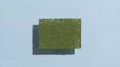 Overhead View of Green Powder Casting Shadows on Azure