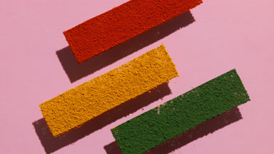 Colorful Powder Stripes on Transparent Surface on pink backdrop