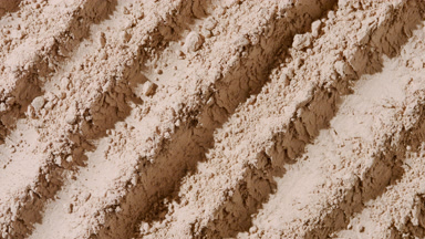 Flowing Dynamic Shadows on Beige Powder Furrows Surface