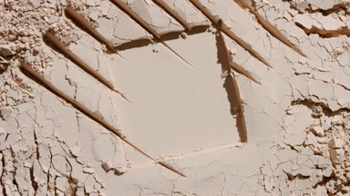 Beige Powder Surface with Chaotic Marks and Dynamic Shadows