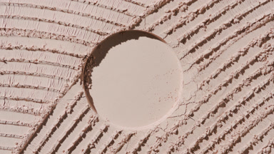 Promotional Capture of Beige Powder Surface with Shadows