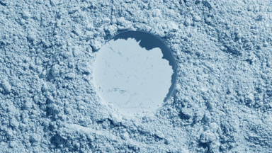 Pale Blue Powder Surface with Circular Stamp and Shadows