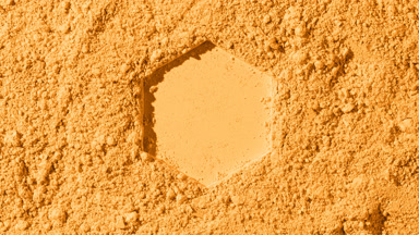 Illuminated Yellow Powder Surface with Hexagonal Pattern