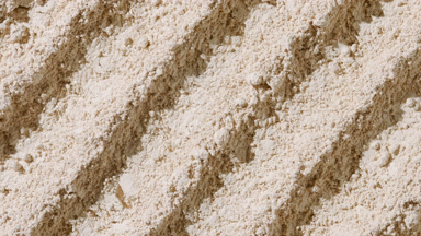 Beige Powder Surface with Furrows and Flowing Shadows