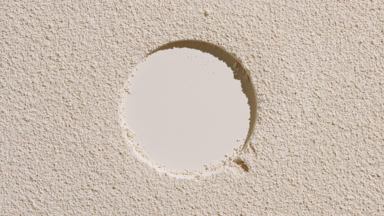 Beige Powder Surface with Circular Mark and Dynamic Shadows
