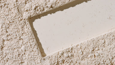 Beige Powder Surface with Dragged Rectangle Imprint