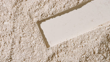 Shifting Shadows on Beige Powder Surface