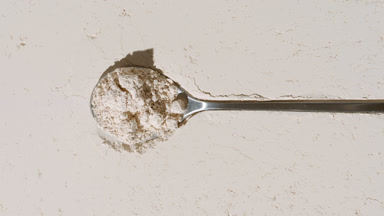 Beige Powder Surface with Measuring Spoon and Light