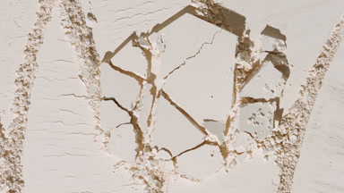 Cracked Pressed Powder on Beige Surface