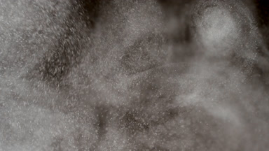 Floating White Dust Particles on Black Background
