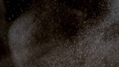 Drifting White Dust Cloud on Dark Background