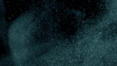 Floating Cyan Powder Dust on Black Background