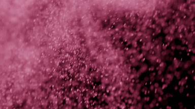 Floating Pink Dust Particles on Black Background
