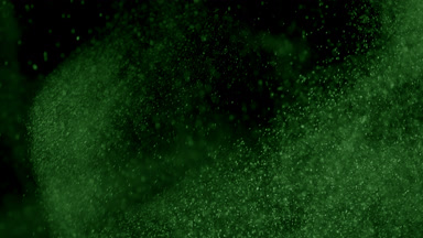 Floating Green Powder Dust on Black Background