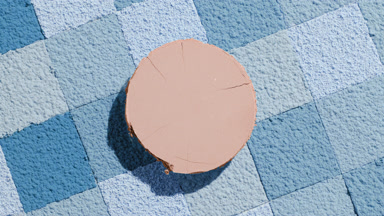 Beige Powder Casting Shadow on Blue Mosaic Surface