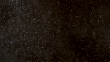Floating White Dust Particles on Black Background