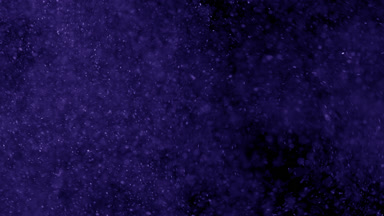 Floating Violet Dust Particles on Black Background