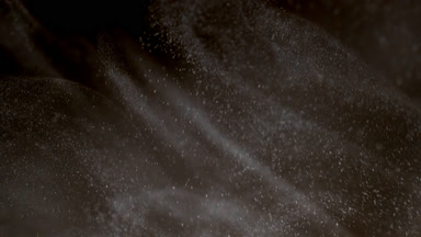 Floating White Powder Dust on Dark Background