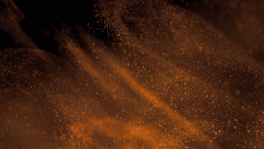 Floating Yellow Powder Dust on Dark Background